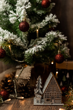 New Year's greeting card with Christmas tree and decorations. House with reindeer. High quality photoの写真素材