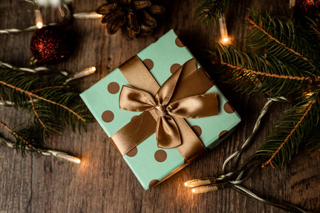 A box with a Christmas gift under the Christmas tree. New Year's Eve Surprise. High quality photoの写真素材