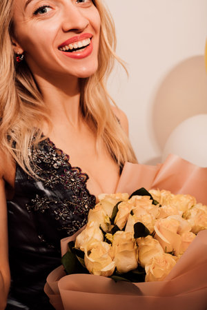 Beautiful woman with a bouquet of roses. Happy laughing woman on white background. High quality photoの写真素材