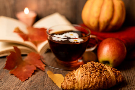 A cup of tea on the table. Autumn composition with tea and croissant. Home comfort. High quality photoの写真素材