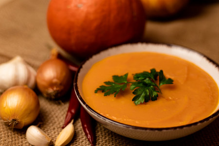 Pumpkin soup in a bowl on the table. Autumn healthy food. Ingathering. High quality photoの写真素材