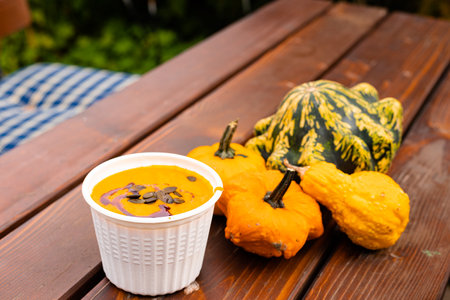 Ingathering. Pumpkins are lying on the table. Lots of pumpkins on the market. High quality photoの写真素材
