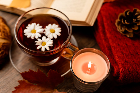 Autumn composition, tea, pumpkins, candle on the table. Autumn comfort at home. High quality photoの写真素材