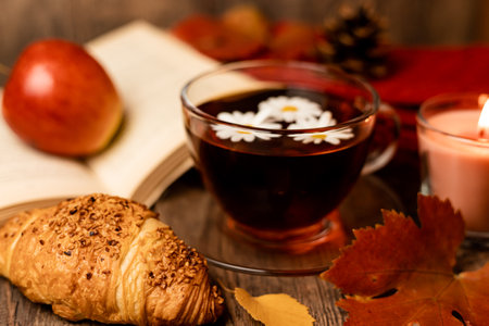 Autumn composition, tea, pumpkins, candle on the table. Autumn comfort at home. High quality photoの写真素材
