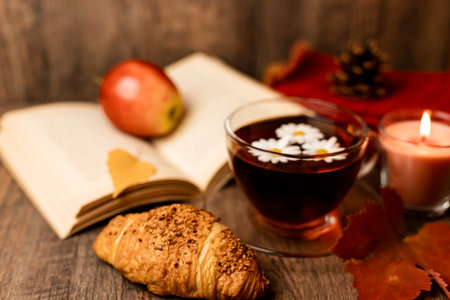 Autumn composition, tea, pumpkins, candle on the table. Autumn comfort at home. High quality photoの写真素材
