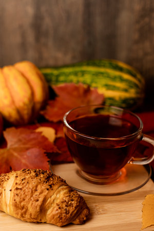Autumn composition, tea, pumpkins, candle on the table. Autumn comfort at home. High quality photoの写真素材