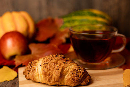 Autumn composition, tea, pumpkins, candle on the table. Autumn comfort at home. High quality photoの写真素材