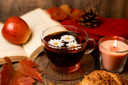 Autumn composition, tea, pumpkins, candle on the table. Autumn comfort at home. High quality photoの写真素材
