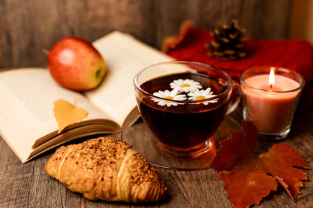Autumn composition, tea, pumpkins, candle on the table. Autumn comfort at home. High quality photoの写真素材