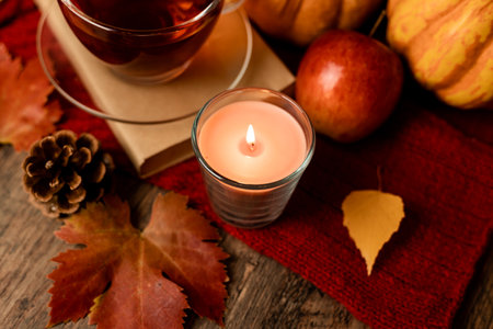 Autumn composition, tea, pumpkins, candle on the table. Autumn comfort at home. High quality photoの写真素材