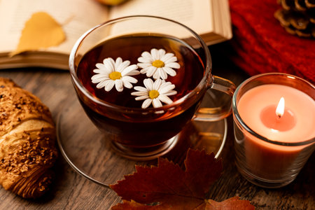 Autumn composition, tea, pumpkins, candle on the table. Autumn comfort at home. High quality photoの写真素材