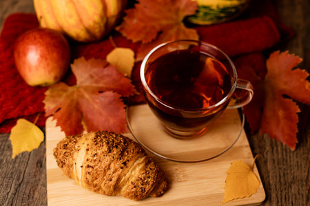 Autumn composition, tea, pumpkins, candle on the table. Autumn comfort at home. High quality photoの写真素材