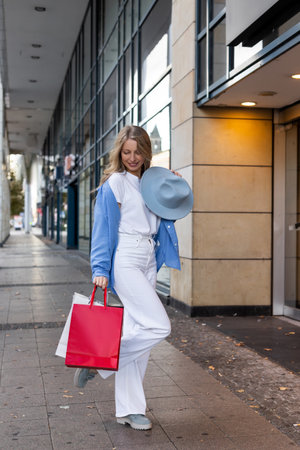 A woman walks around the city after shopping. Buying clothes. Black Friday Deals. High quality photoの写真素材