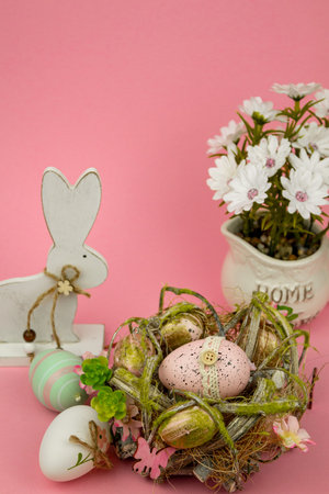 Multi-colored apschal eggs on a pink background. Easter bunny. Spring Flowers. High quality photo