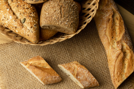 Pieces of sliced ciabata are lying on the table. Cooking. Breakfast. Breads. High quality photoの写真素材