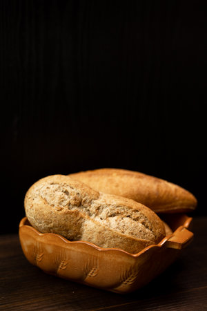 Homemade freshly baked bread on a plate on a black background. High quality photoの写真素材
