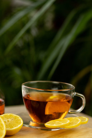 Glass cup of tea, teapot, sliced lemons on the table. Kettle with tea. Lemon teaの写真素材