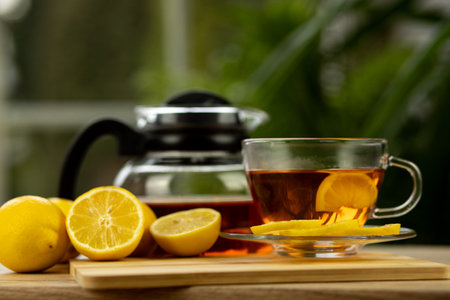 Glass cup of tea, teapot, sliced lemons on the table. Kettle with tea. Lemon teaの写真素材