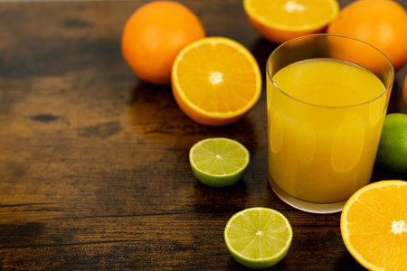 A healthy smoothie in a glass with oranges and lime. Glass of orange juice. High quality photoの写真素材