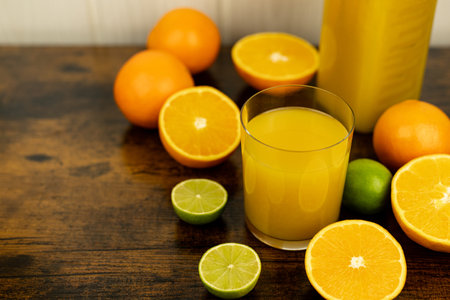A healthy smoothie in a glass with oranges and lime. Glass of orange juice. High quality photoの写真素材