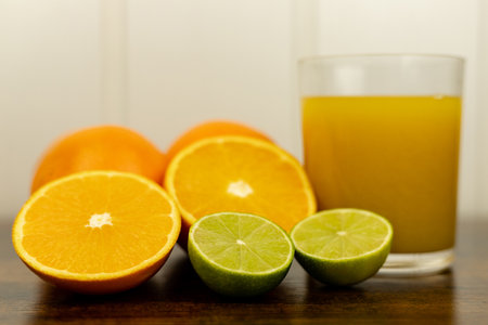 A healthy smoothie in a glass with oranges and lime. Glass of orange juice. High quality photoの写真素材