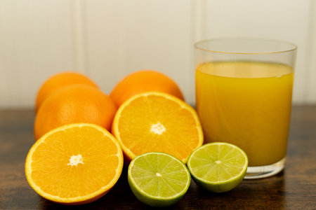 A healthy smoothie in a glass with oranges and lime. Glass of orange juice. High quality photoの写真素材