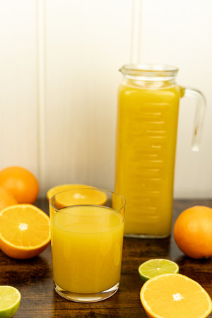 A healthy smoothie in a glass with oranges and lime. Glass of orange juice. High quality photoの写真素材
