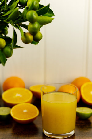 Sliced oranges, a close-up glass of freshly squeezed orange juice. Fresh juice. High quality photoの写真素材