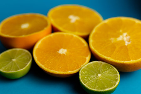Lots of cut oranges on a blue background, top view. A steep plan. Background with oranges. High quality photoの写真素材