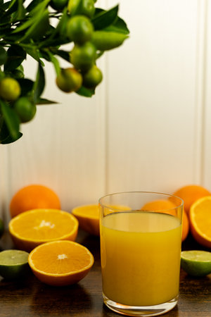 Close-up of cut oranges on a table. Orange juice in a glass. High quality photoの写真素材