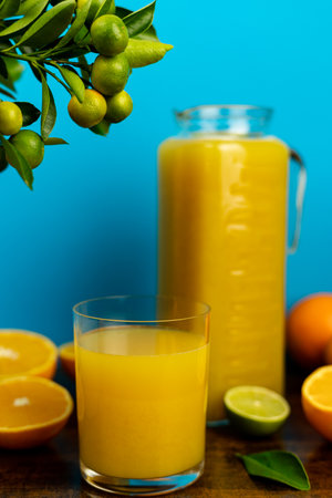 Close-up of cut oranges on a table. Orange juice in a glass. High quality photoの写真素材
