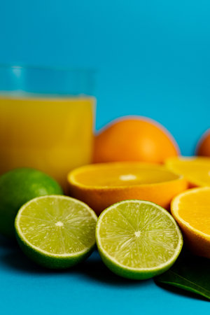 Close-up of cut oranges on a table. Orange juice in a glass. High quality photoの写真素材