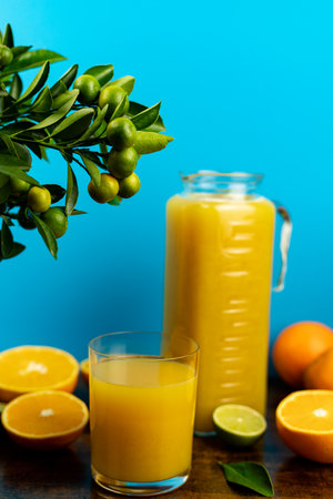 Close-up of cut oranges on a table. Orange juice in a glass. High quality photoの写真素材