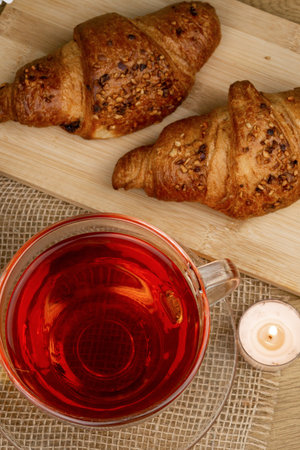 Croissants and tea on the table, view from above. Delicious aromatic breakfast. High quality photoの写真素材