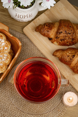 Croissants and tea on the table, view from above. Delicious aromatic breakfast. High quality photoの写真素材