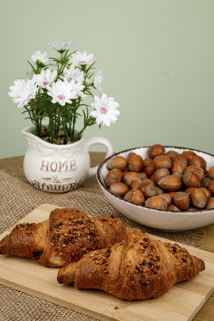 Croissants and hazelnuts on the table. Delicious healthy breakfast. Top view. High quality photoの写真素材