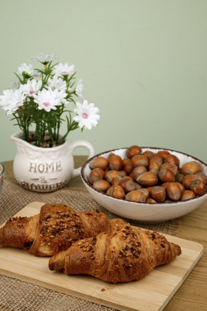 Croissants and hazelnuts on the table. Delicious healthy breakfast. Top view. High quality photoの写真素材