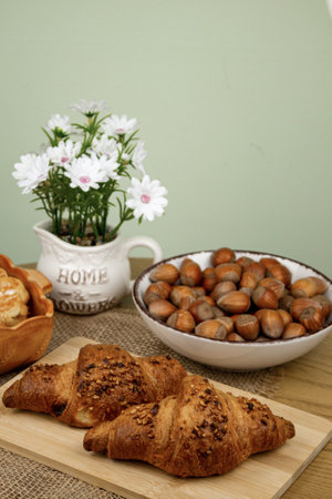 Croissants and hazelnuts on the table. Delicious healthy breakfast. Top view. High quality photoの写真素材