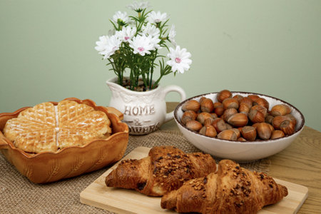 Croissants and hazelnuts on the table. Delicious healthy breakfast. Top view. High quality photoの写真素材