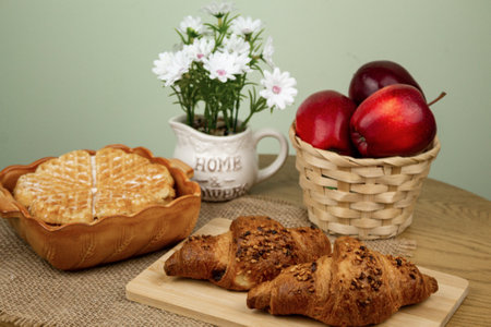 Freshly baked waffle on the table. Red apples in a basket on the table. Delicious and healthy breakfast. High quality photoの写真素材