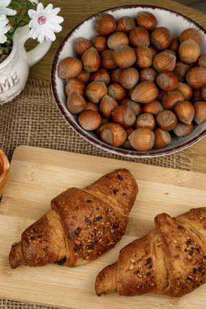Croissants and hazelnuts on the table. Delicious healthy breakfast. Top view. High quality photoの写真素材