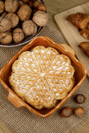 Delicious homemade waffles on the table. Walnuts and croissants. High quality photoの写真素材