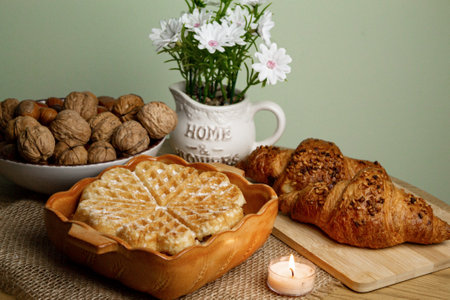 Delicious homemade waffles on the table. Walnuts and croissants. High quality photoの写真素材