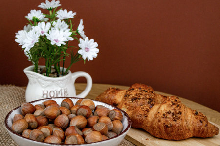 Croissants and hazelnuts on the table. Delicious healthy breakfast. Top view. High quality photoの写真素材