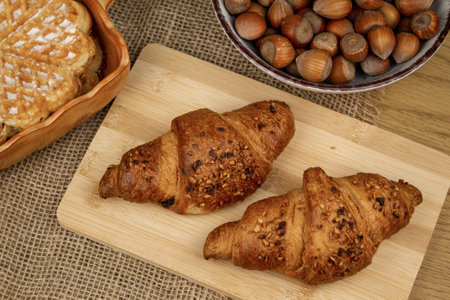 Croissants and hazelnuts on the table. Delicious healthy breakfast. Top view. High quality photoの写真素材