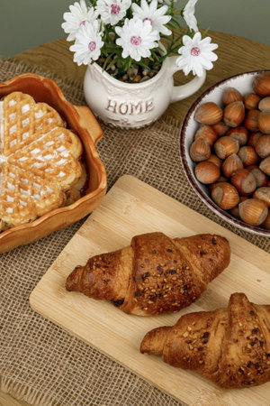 Croissants and hazelnuts on the table. Delicious healthy breakfast. Top view. High quality photoの写真素材