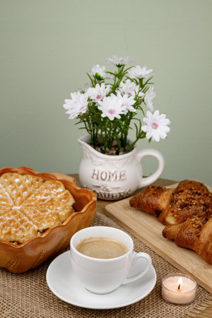 A cup of coffee, waffles and croissants on the table. Breakfast with coffee. Homemade pastries. Top view. High quality photoの写真素材