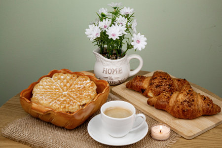 A cup of coffee, waffles and croissants on the table. Breakfast with coffee. Homemade pastries. Top view. High quality photoの写真素材