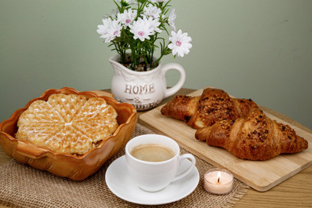 A cup of coffee, waffles and croissants on the table. Breakfast with coffee. Homemade pastries. Top view. High quality photoの写真素材