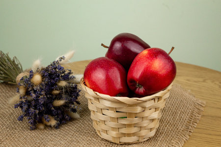 Red beautiful apples in a basket on the table. Red apples. Apple diet. High quality photoの写真素材